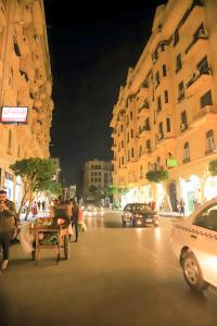 a city street at night with cars and buildings at King palace castle hotel in Cairo +47 photos