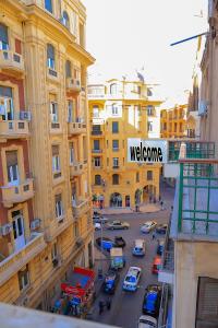 a view of a city street with a sign that reads welcome at King palace castle hotel in Cairo
