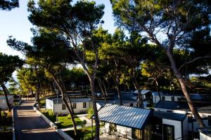 an overhead view of a street with trees and houses at Waterman Beach Village in Supetar