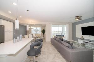 a kitchen and living room with a couch and a table at 3120-206DR STOREY LAKE, CONDO 2/2 GARDEN VIEW in Kissimmee