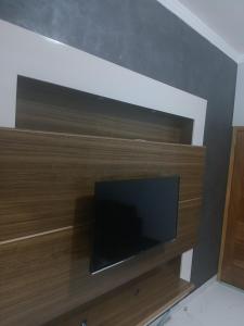 a flat screen tv sitting on top of a wall at Casa Encanto in Franca +6 photos