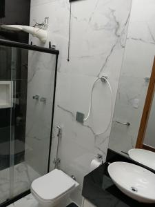 a bathroom with a toilet and a glass shower at Casa Encanto in Franca