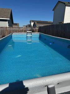 una piscina azul con una silla. en Cozy Stay with Pool Relax with Easy Access to Highway, en Maxwell