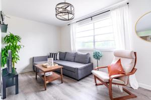 a living room with a couch and a chair at Short North Convention Private Parking Pets! in Columbus