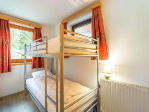 a bedroom with two bunk beds in a room at Zederhaus in Mariapfarr