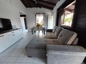 a living room with a couch and a table at Kaz'Agatha in Sainte-Anne