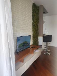 a flat screen tv sitting on top of a wooden table at Apartment in the heart of Joinville in Joinville