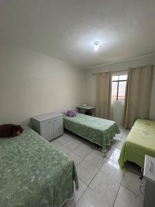 a hospital room with two beds and a window at Apartamento no Centro de Mariana in Mariana