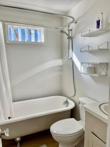 a bathroom with a tub and a toilet and a sink at Downtown Updated Craftsman, Pet Friendly in Sonora