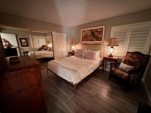 a bedroom with a bed and a chair at Charming & Cozy 2-Bedroom in the Heart of Cathedral City! in Cathedral City +24 photos
