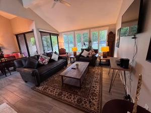 a living room with couches and a coffee table at Charming & Cozy 2-Bedroom in the Heart of Cathedral City! in Cathedral City