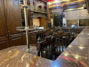a bar in a restaurant with a counter and chairs at شقق المومني in Amman