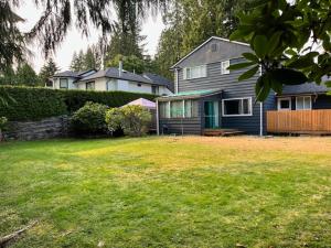 a house in a yard with a yard sidx sidx sidx at Edgewood Road in North Vancouver