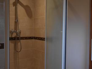 a bathroom with a shower with a glass door at Maison de Caractère Rénovée avec Jardin, Terrasse, et Proche du Château Guillaume - FR-1-591-131 in Lignac