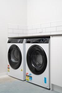 two washing machines sitting next to each other at The Alpine Lakeview Luxe Retreat in Queenstown