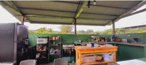 a kitchen with a table and a green wall at Cabañas DondeJosé in Valle de Anton +57 photos