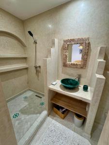 a bathroom with a sink and a shower at Riad Lalla Naty in Agadir +12 photos