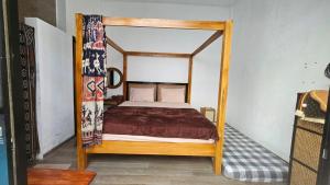 a bedroom with a canopy bed in a room at Vila Raima SYARIAH in Gresik