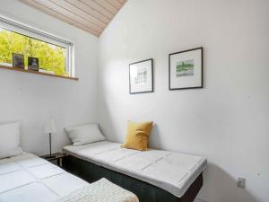 a white room with two beds and a window at 5 star holiday home in Allingåbro in Rygård Strand