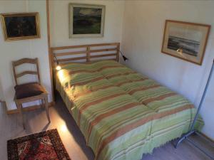 a bedroom with a bed and a chair in a room at 5 star holiday home in Søby Ærø in Soby Mark