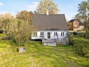 a white house in the middle of a field at 5 star holiday home in Søby Ærø in Soby Mark