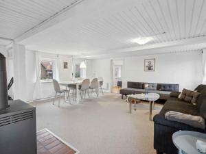 a living room with a couch and a table at 5 star holiday home in Haderslev in Flovt