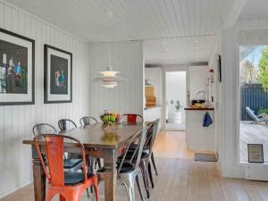 a dining room with a wooden table and chairs at 5 star holiday home in Hillerød in Nejede +14 photos