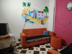a living room with a couch and a painting on the wall at Venti house in Aswan