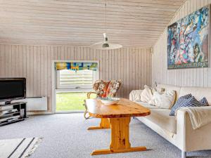 a living room with a couch and a table at 5 star holiday home in Store Fuglede in Ornum