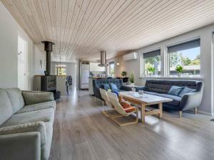 a living room with couches and a table at 5 star holiday home in Vig in Hønsinge