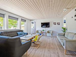 a living room with two couches and a table at 5 star holiday home in Vig in Hønsinge