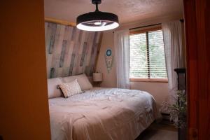 a bedroom with a bed and a window at Covered Hot Tub Getaway Sleeps 9 in Duck Creek Village