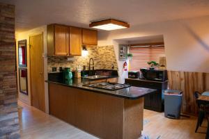 a kitchen with a sink and a counter top at Covered Hot Tub Getaway Sleeps 9 in Duck Creek Village