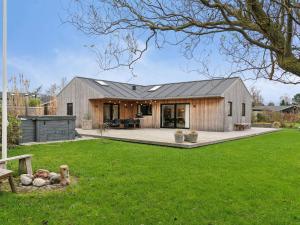 a barn style house with a large backyard at 5 star holiday home in Odder in Norsminde
