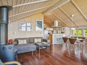 a living room with a couch and a table at 5 star holiday home in Skælskør in Egerup