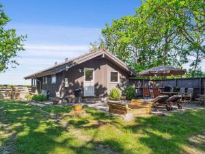 a small house with a patio and a backyard at 5 star holiday home in Skælskør in Egerup