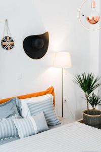 a bedroom with a bed with a hat on the wall at Quiet room, hall, shared bathroom and kitchen in Athens