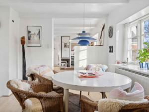 a kitchen and living room with a white table and chairs at 5 star holiday home in Nykøbing M in Tæbring