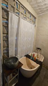 a bathroom with a sink and a bath tub at Vila Raima SYARIAH in Gresik
