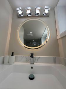 a bathroom with a mirror and a sink at Modern 2 Bedroom Suite, Excellent Location Near Downtown & Airport in Kitchener +88 photos