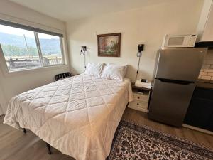 a bedroom with a bed and a window at Basecamp in Sagle +2 photos
