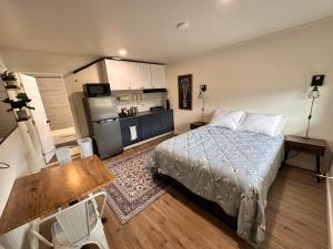 a small bedroom with a bed and a kitchen at Basecamp in Sagle