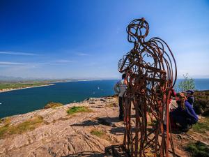 a group of people standing on top of a mountain at Captain's House in Morfa Nefyn