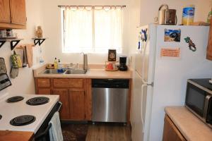 a kitchen with a white refrigerator and a sink at Adventure Base #2 by Lake Powell in Big Water