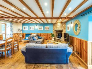 a living room with blue walls and a blue couch at Seaton Cottage - Uk31990 in Staithes