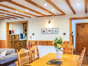 a dining room with a wooden table and chairs at Seaton Cottage - Uk31990 in Staithes