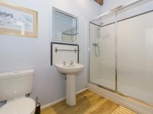 a bathroom with a shower and a toilet and a sink at Ingleby Barn - 27946 in Battersby +4 photos