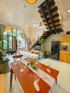 a dining room with a table and wine glasses at Terralia Villa in La Gi +54 photos