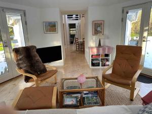 a living room with two chairs and a tv at 5 star holiday home in Rørvig in Rørvig