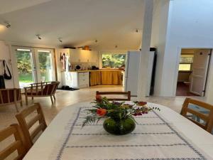 a kitchen with a table with a vase of flowers on it at 5 star holiday home in Rørvig in Rørvig +10 photos